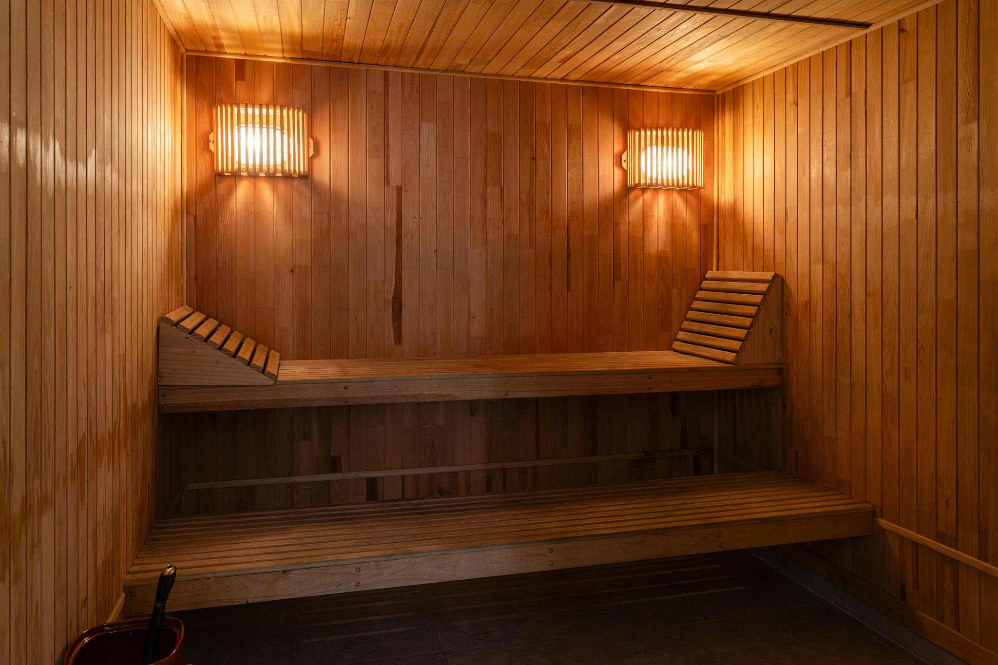 A warm, inviting wooden sauna interior with soft lighting for a relaxing spa experience.