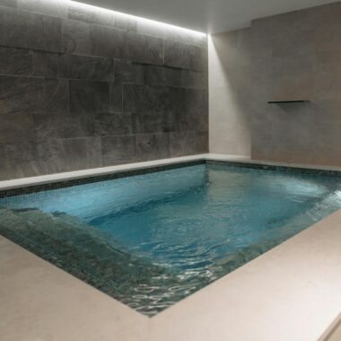 Elegant indoor spa pool with modern stone tile interior, perfect for relaxation.